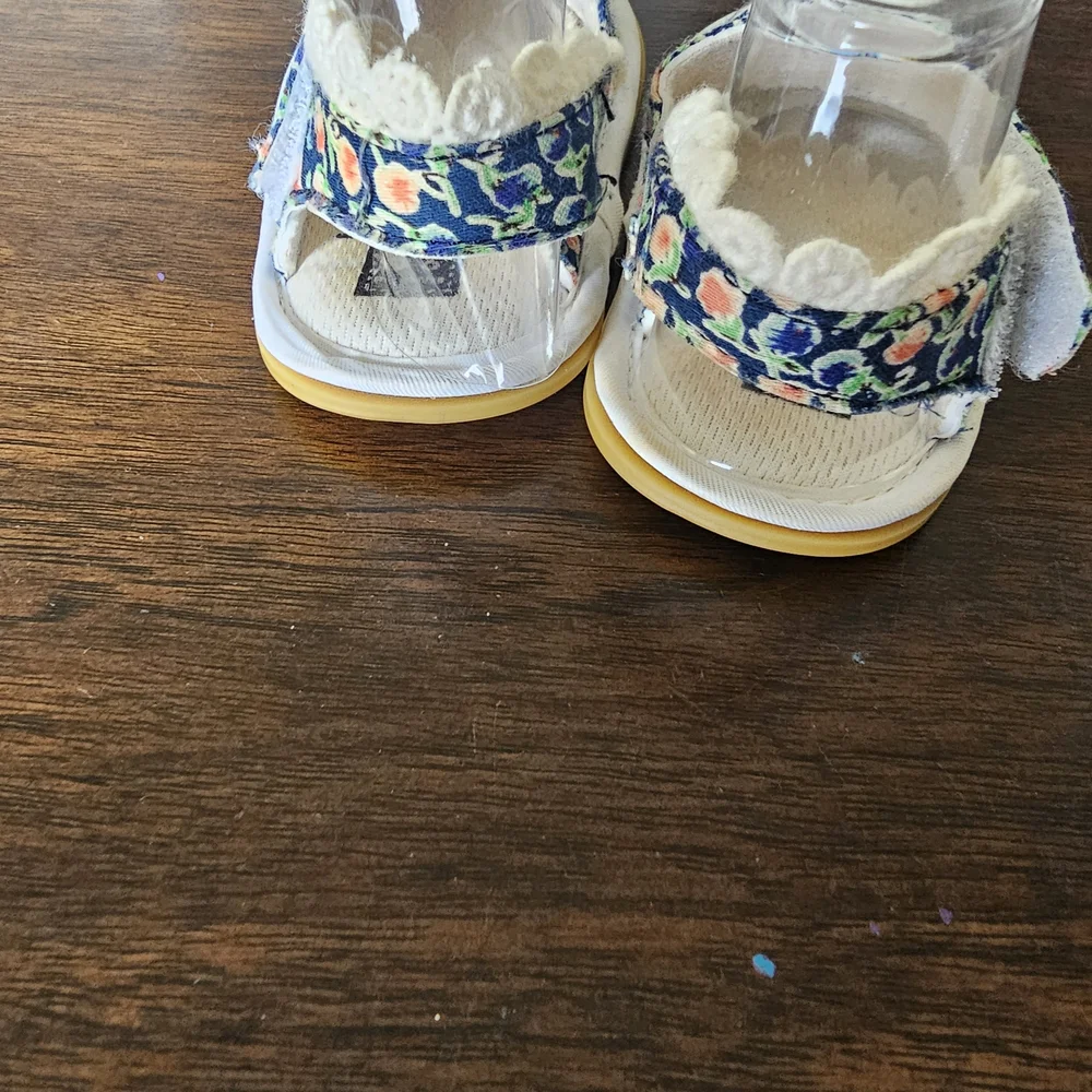 3 pairs of baby/girl shoes—soft, floral, and glittery—in various styles.
